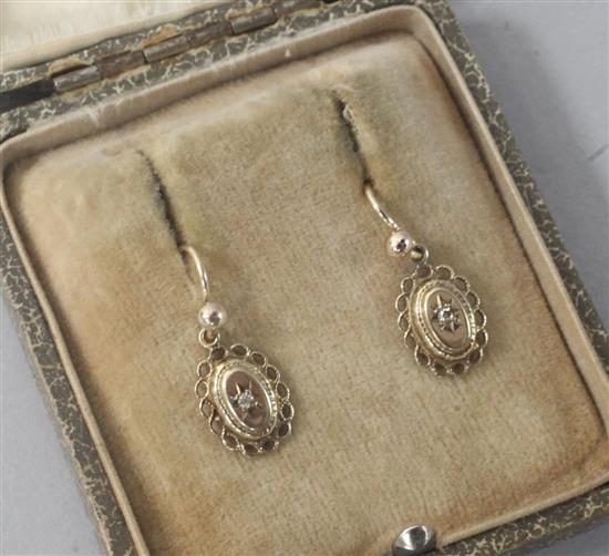 A pair of gold and diamond set oval earrings.